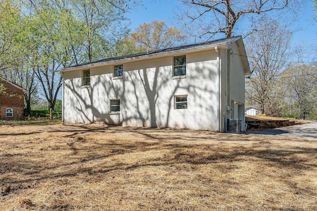 back of house featuring brick siding