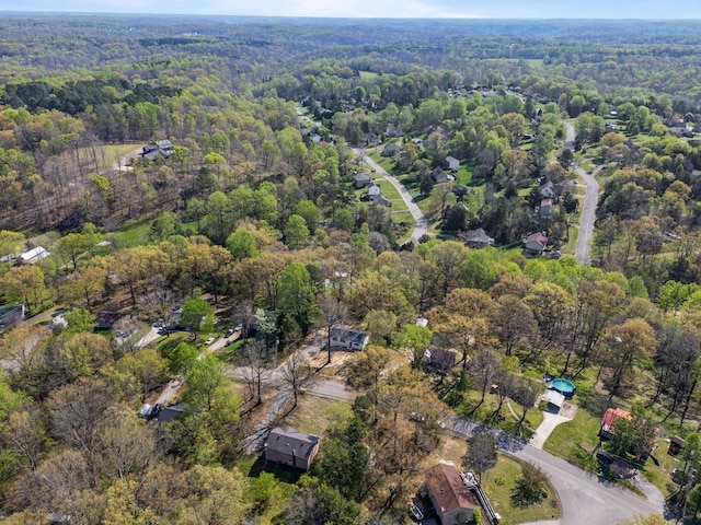 drone / aerial view featuring a wooded view