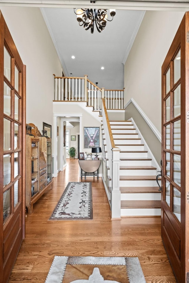 113 St Charles Way, Gallatin, TN 37066 - entrance foyer with crown molding, stairs, a chandelier, baseboards, and wood finished floors