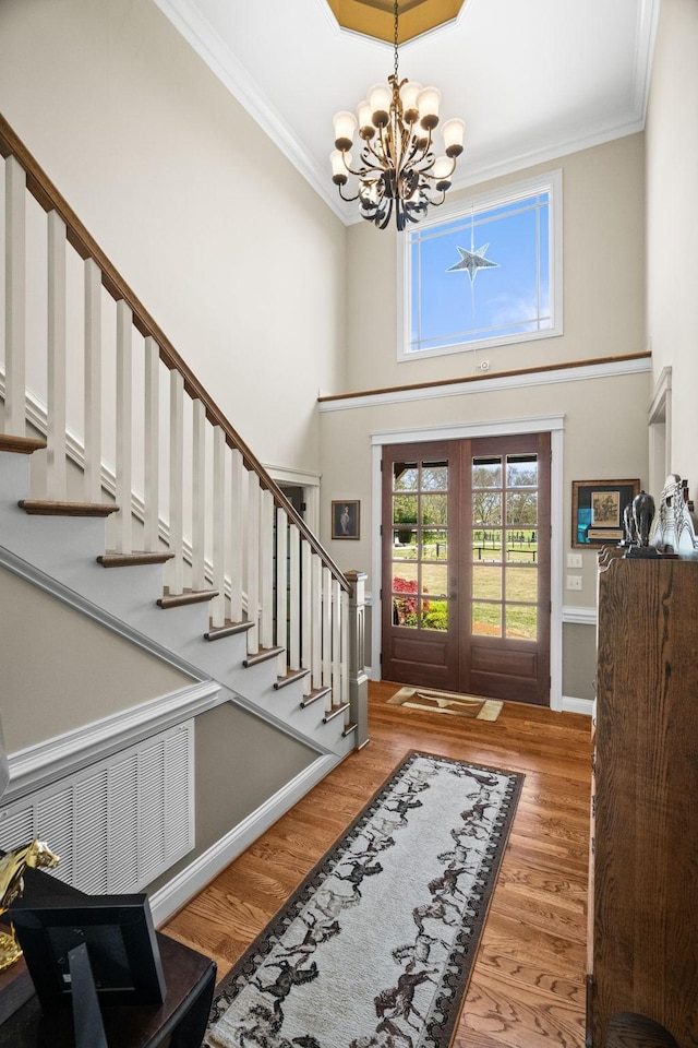 113 St Charles Way, Gallatin, TN 37066 - foyer featuring a chandelier, stairs, wood finished floors, crown molding, and a towering ceiling