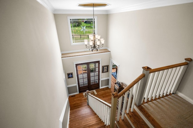 113 St Charles Way, Gallatin, TN 37066 - foyer with french doors, a chandelier, wood finished floors, baseboards, and ornamental molding