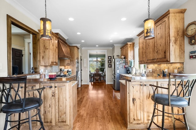 113 St Charles Way, Gallatin, TN 37066 - kitchen featuring stainless steel appliances, premium range hood, a peninsula, recessed lighting, and backsplash