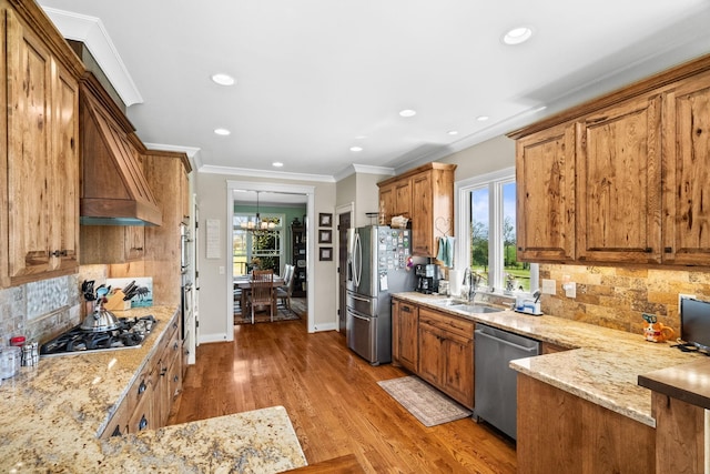 113 St Charles Way, Gallatin, TN 37066 - kitchen with appliances with stainless steel finishes, a sink, light stone countertops, backsplash, and brown cabinets