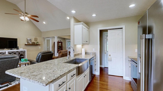 kitchen featuring open floor plan, ceiling fan, a sink, and appliances with stainless steel finishes