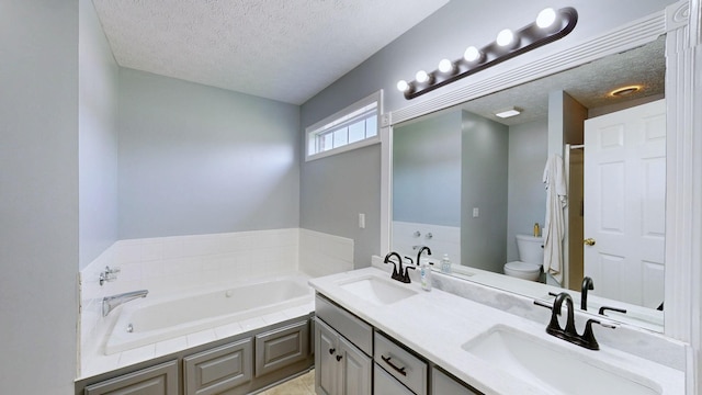 full bathroom with toilet, a textured ceiling, a garden tub, and a sink