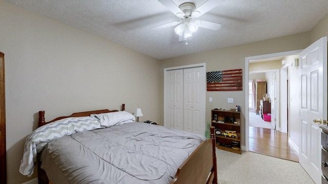 bedroom with a closet, ceiling fan, and light colored carpet