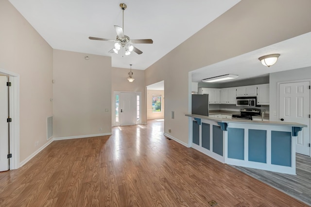 308 Wareham Ct, Antioch, TN 37013 - kitchen featuring visible vents, white cabinetry, wood finished floors, and appliances with stainless steel finishes