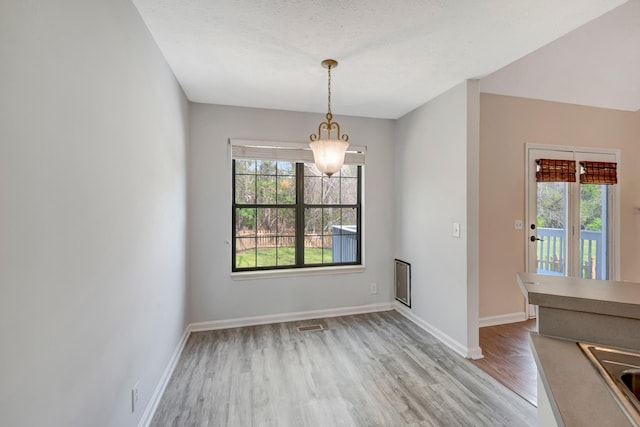 308 Wareham Ct, Antioch, TN 37013 - unfurnished dining area featuring visible vents, light wood-style flooring, and baseboards