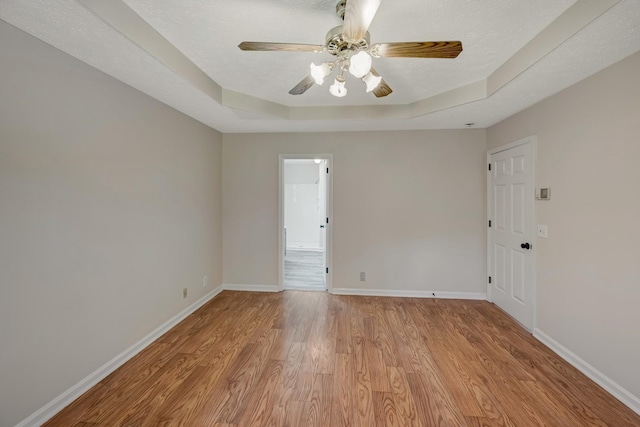 308 Wareham Ct, Antioch, TN 37013 - unfurnished room featuring baseboards, light wood-style flooring, a textured ceiling, a tray ceiling, and ceiling fan