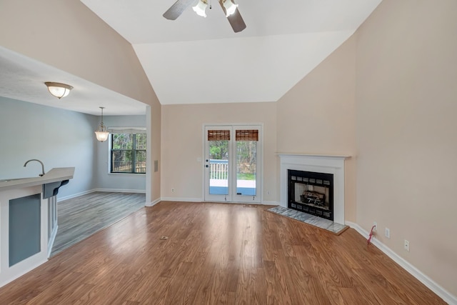 308 Wareham Ct, Antioch, TN 37013 - unfurnished living room featuring a fireplace, a ceiling fan, wood finished floors, lofted ceiling, and baseboards