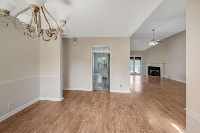 308 Wareham Ct, Antioch, TN 37013 - interior space with light wood-style flooring, ceiling fan with notable chandelier, a fireplace, and baseboards