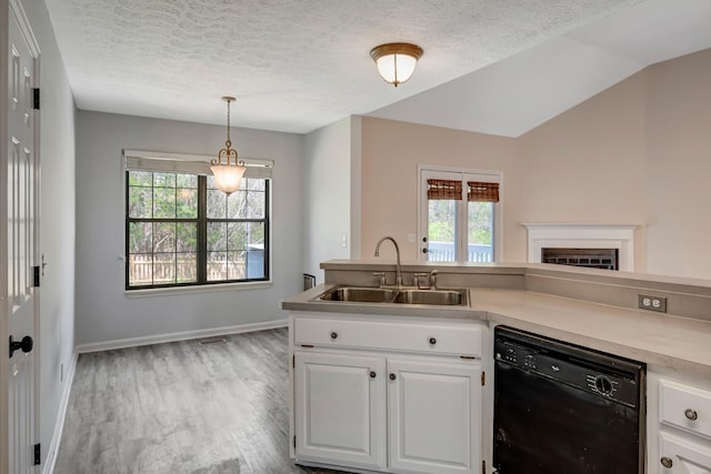308 Wareham Ct, Antioch, TN 37013 - kitchen featuring a textured ceiling, dishwasher, light countertops, a sink, and baseboards