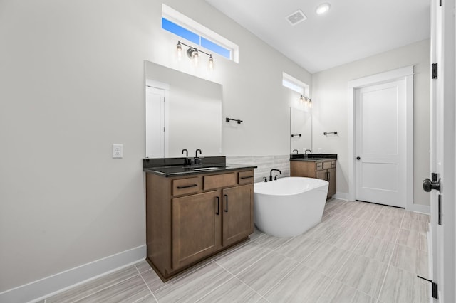 5818 Willoughby Way, Murfreesboro, TN 37129 - bathroom with visible vents, a freestanding bath, two vanities, a sink, and baseboards