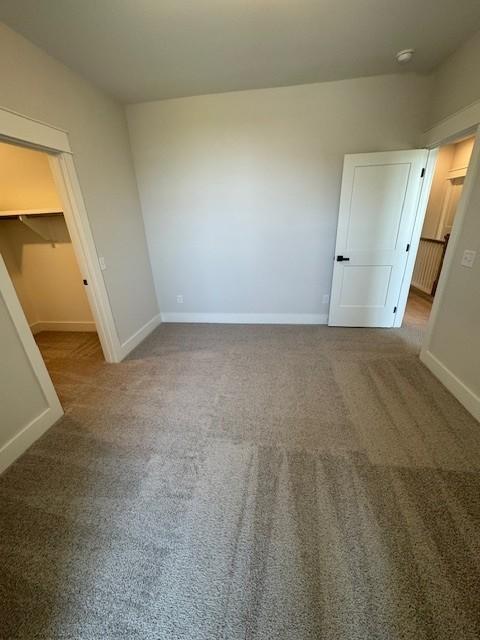 5818 Willoughby Way, Murfreesboro, TN 37129 - unfurnished bedroom featuring a spacious closet, carpet, and a closet