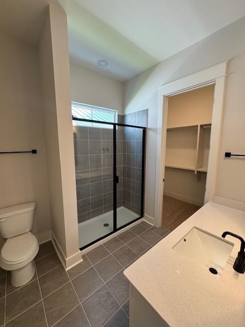 5818 Willoughby Way, Murfreesboro, TN 37129 - bathroom featuring vanity, tile patterned flooring, a stall shower, and a walk in closet