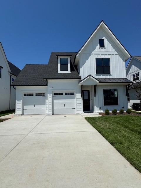5818 Willoughby Way, Murfreesboro, TN 37129 - modern farmhouse with board and batten siding, driveway, a front yard, an attached garage, and a standing seam roof