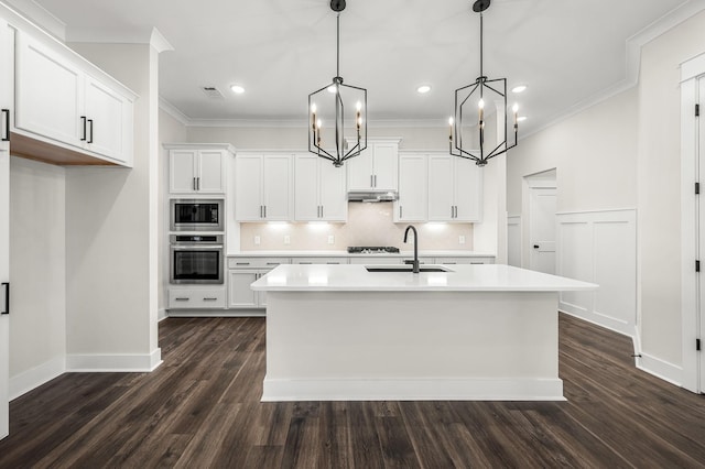 kitchen featuring a sink, light countertops, built in microwave, and stainless steel oven