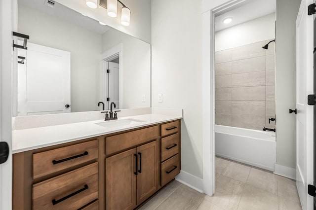 bathroom with vanity, tile patterned floors, baseboards,  shower combination, and visible vents