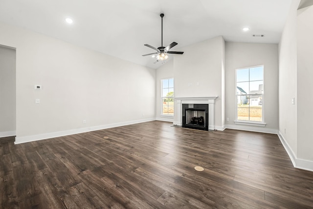 unfurnished living room with a fireplace with flush hearth, ceiling fan, dark wood finished floors, and visible vents
