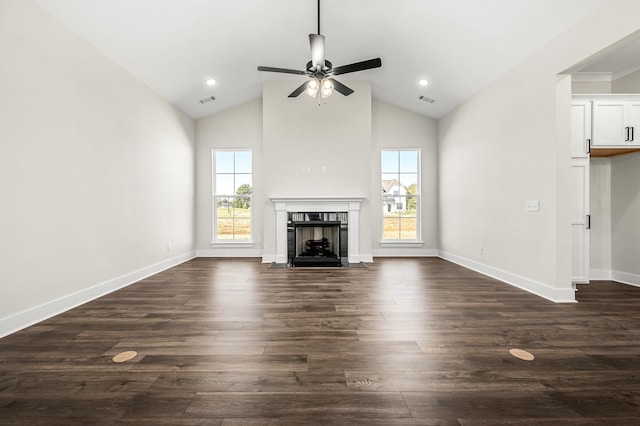 unfurnished living room featuring visible vents, a ceiling fan, dark wood finished floors, and a tile fireplace