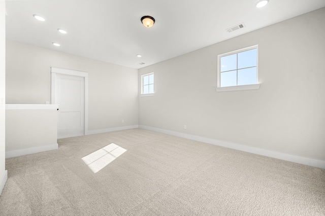 empty room featuring visible vents, recessed lighting, baseboards, and carpet floors