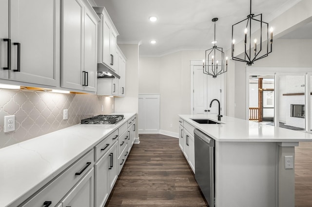 kitchen with a sink, stainless steel appliances, baseboards, recessed lighting, and under cabinet range hood