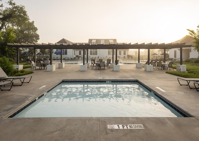 pool with a patio area and a pergola
