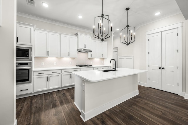kitchen with white cabinets, oven, visible vents, and built in microwave