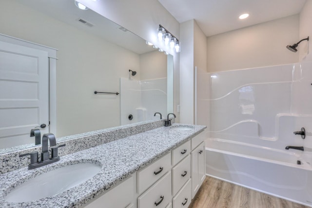 2240 Eugene Reed Rd, Woodbury, TN 37190 - full bath featuring bathing tub / shower combination, visible vents, a sink, and wood finished floors