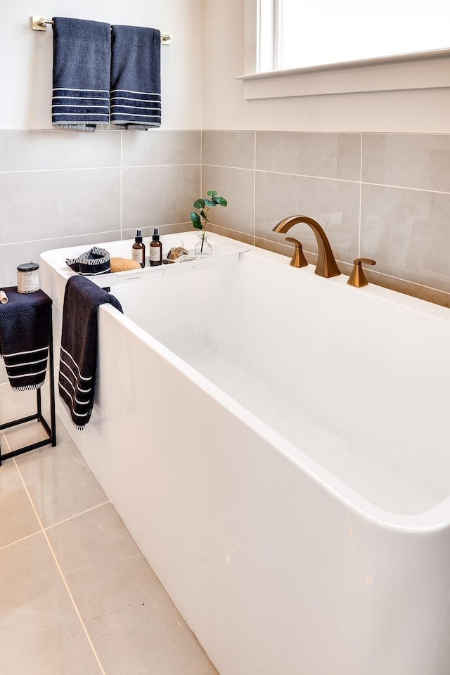 full bath featuring a freestanding bath and tile patterned floors