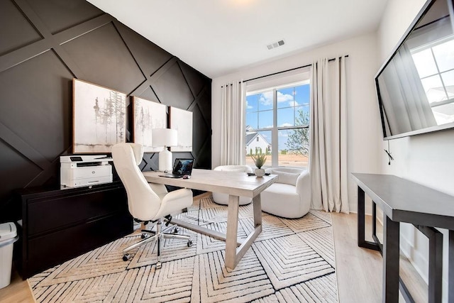 home office featuring visible vents and light wood-type flooring