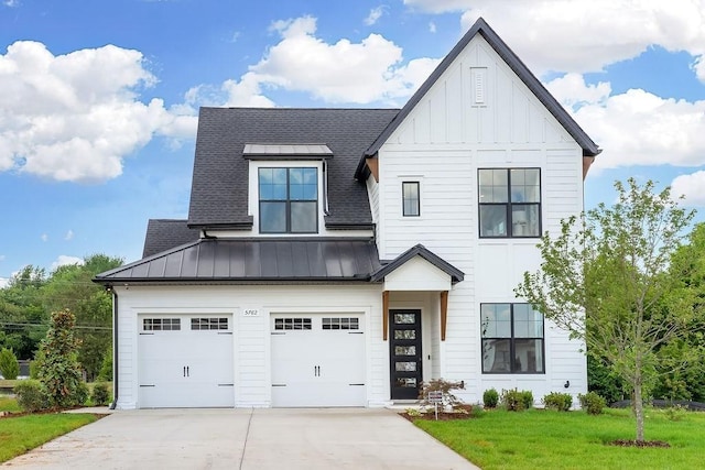 modern inspired farmhouse with roof with shingles, an attached garage, board and batten siding, a standing seam roof, and driveway