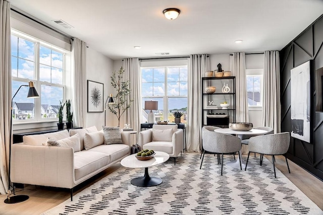 living area featuring wood finished floors and visible vents