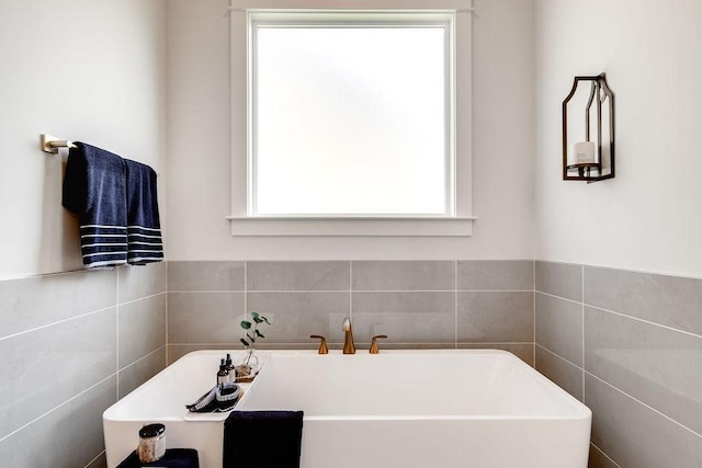 bathroom featuring a freestanding tub and a wealth of natural light