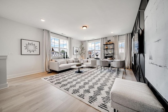 living room featuring light wood-style floors, recessed lighting, and baseboards
