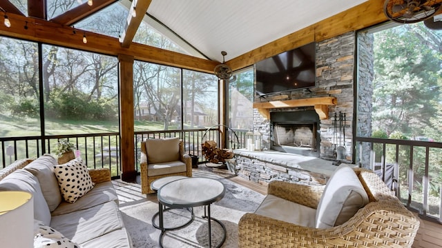 sunroom / solarium featuring an outdoor living space with a fireplace