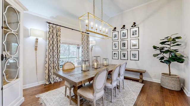 dining room with baseboards, ornamental molding, and hardwood / wood-style flooring