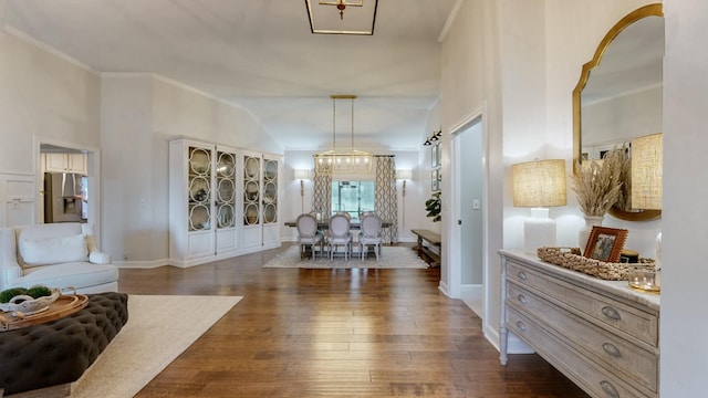 interior space with dark wood-type flooring, baseboards, and crown molding