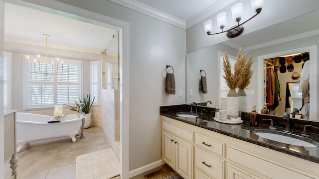 full bath featuring a sink, tile patterned flooring, an inviting chandelier, and a soaking tub