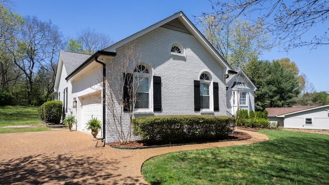 view of property exterior featuring concrete driveway, a yard, brick siding, and an attached garage