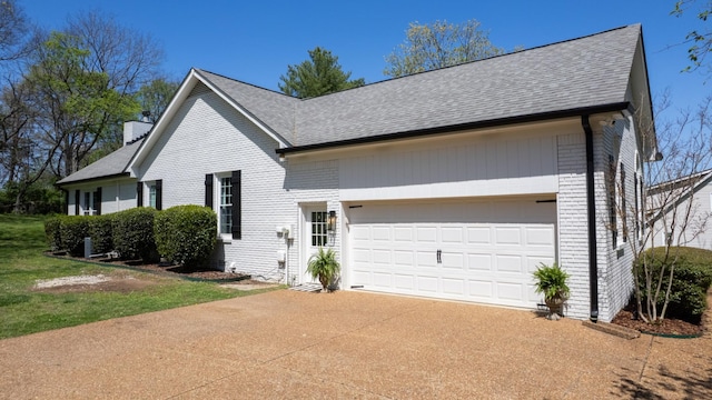 view of front of property featuring concrete driveway, roof with shingles, a chimney, an attached garage, and brick siding