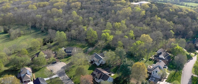 drone / aerial view featuring a view of trees and a residential view