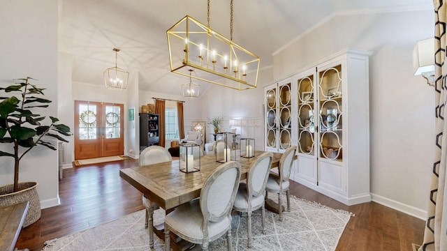 dining room featuring baseboards, a notable chandelier, ornamental molding, wood finished floors, and french doors