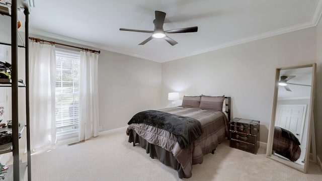 bedroom with ceiling fan, baseboards, ornamental molding, and carpet floors