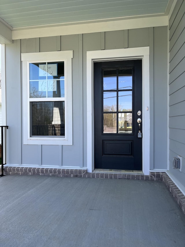 view of exterior entry featuring covered porch