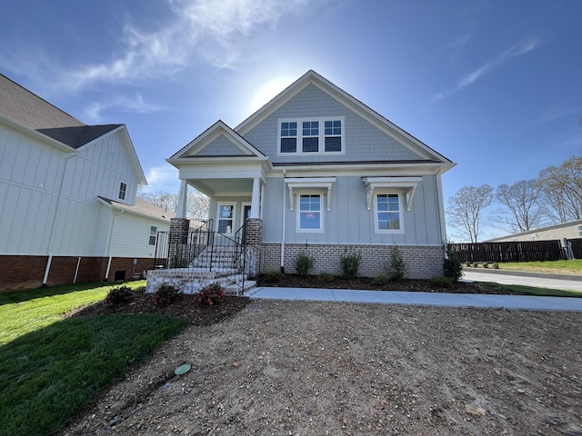 bungalow featuring a porch and board and batten siding