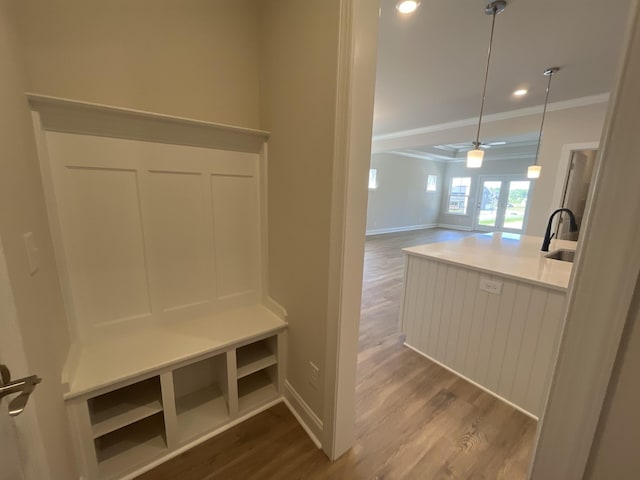 mudroom with recessed lighting, baseboards, ornamental molding, dark wood finished floors, and a sink