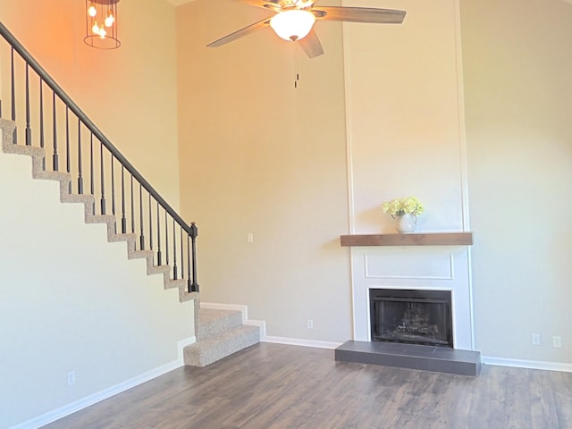 436 Bluff Dr, Clarksville, TN 37043 - unfurnished living room with stairs, a high ceiling, ceiling fan with notable chandelier, and wood finished floors