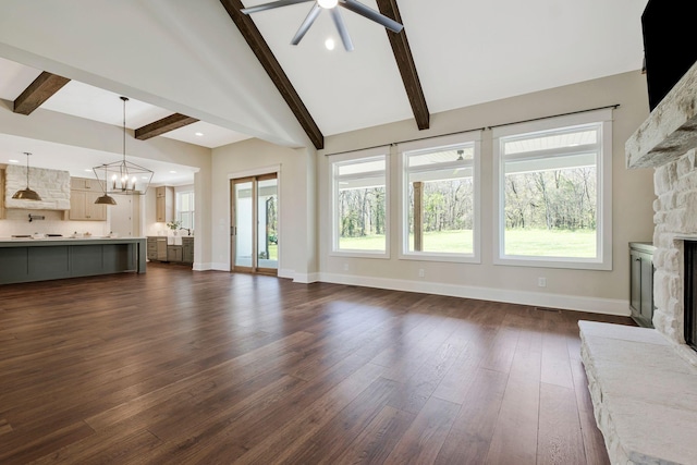 3050 Horn Springs Rd, Lebanon, TN 37087 - unfurnished living room with a stone fireplace, baseboards, dark wood-style floors, a wealth of natural light, and ceiling fan with notable chandelier
