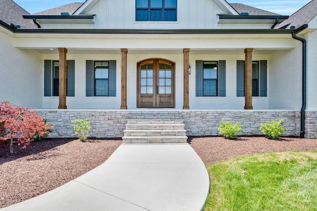 3050 Horn Springs Rd, Lebanon, TN 37087 - view of exterior entry with board and batten siding, a porch, and brick siding